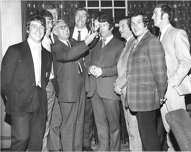Photograph of the late Dai Francis (4th from left) showing a miner’s lamp to the Welsh members of the successful British Lions rugby team of 1971. Included in the photo are Gareth Edwards (2nd right) and coach, the late Carwyn James (3rd right)