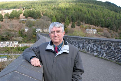Dr Hywel Francis MP at Oakwood with one of the historic Pontrhydyfen Viaducts in the background